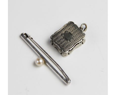 A Victorian silver vinaigrette pendant by Alfred Taylor, Birmingham 1865, of rectangular form with shaped borders and engine 