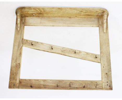 A rustic pine hanging wall rack, with a rectangular shelf above a pair of uprights united by an angled cross member, applied 