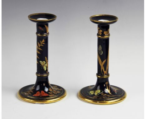 A pair of Worcester Aesthetic candlesticks, circa 1879, each decorated with butterflies and flora, gilt highlighted against a