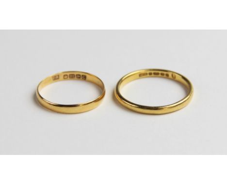 A 22ct gold wedding band, ring size N, together with another example, ring size K, gross weight of pair 3.6gms (2) 