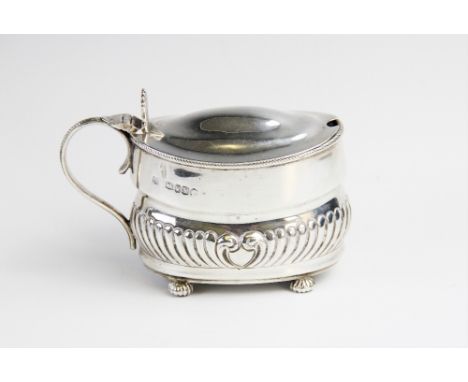 A Victorian silver wet mustard by William Hutton &amp; Sons, London 1887, of oval form with half reeded decoration on four co