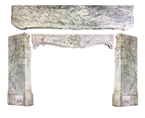 A white and grey variegated marble fire surround, with shell decorated frieze flanked by two stile supports with serpentine m