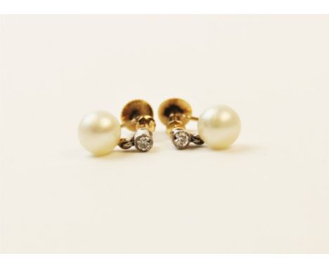 A pair of pearl and diamond drop earrings, each comprising a small old cut diamond of approx. 2.5mm diameter, suspending a ro