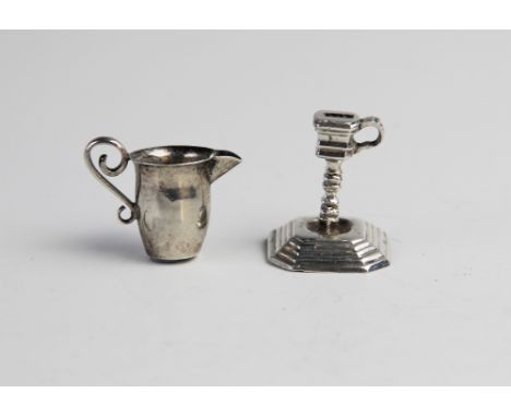 A Dutch silver novelty miniature candlestick, of faceted form with knopped stem on stepped octagonal base, 33mm tall, togethe