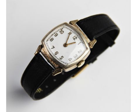 A vintage wristwatch, the white enamel dial with gold toned Arabic numerals and outer seconds track, set to a gold plated cus