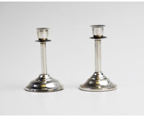A near pair of late Victorian novelty silver miniature candlestick, each of plain polished form on weighted spreading circula