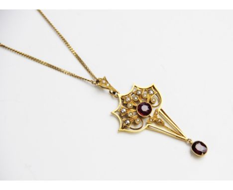 An Edwardian untested ruby and seed pearl set pendant, comprising a round mixed cut ruby measuring 6mm diameter, set in yello