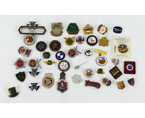 A collection of assorted metal and enamel lapel badges, including BSA, Ducati, AJS, BMC Drivers Club etc. 