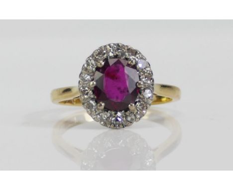 An 18ct Gold, Ruby and Old Cut Diamond Cluster Ring, 7.4x6.5mm principal stone, 12.4x11.1mm head, size M.5, stamped 18CT, 4.2