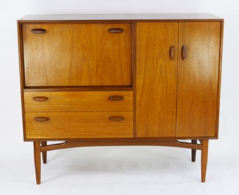 A G-Plan teak drinks cabinet/sideboard, by E Gomme, of rectangular outline, containing a fall front compartment with two draw