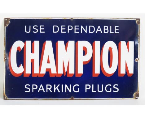 An enamel advertising sign, "Use Dependable Champion Sparking Plugs " 32 x 53cm. 