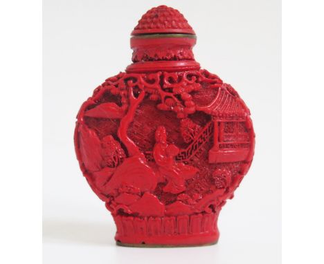 A Chinese faux cinnabar lacquer scent bottle, of moon-shaped outline decorated with figures in a pagoda landscape. 6.5cm high