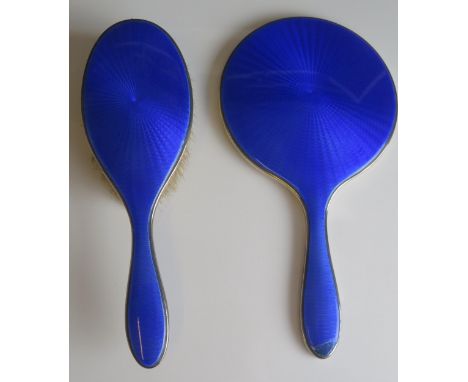 An Edward VII silver and enamel backed hairbrush and hand mirror, maker Adie Bros Ltd, Birmingham, 1902. (2) 