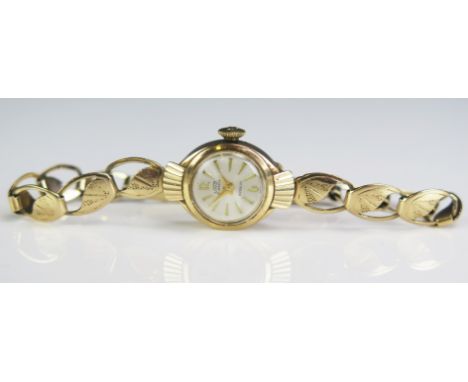 An Uno Lady's 9ct Gold Manual Wind Wristwatch on a 9ct gold bracelet,&nbsp; 7.4g nett. Running