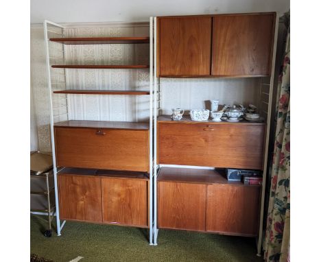 A three section vintage Ladderax shelving unit, with five cupboard units and three open shelves, having four metal uprights a