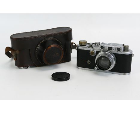 A Leica IIIC rangefinder camera, serial No 312322, fitted with a Summar f=35mm 1:2 lens, contained in a leather case. 