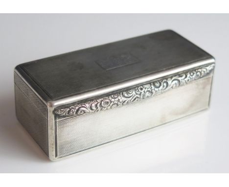 A George IV silver snuff box, maker J.I?, London, 1823, inscribed, of rectangular outline, with floral decorated edge, and en