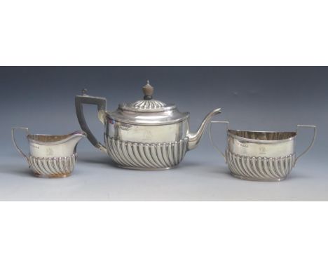 A Victorian three-piece silver bachelors tea service, maker Harrison Brothers &amp; Howson, Sheffield, 1885, crested of oval 