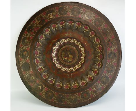 An Indian circular brass and enamel tiffin table of lobed design decorated with circular panels of figures enclosed within fl