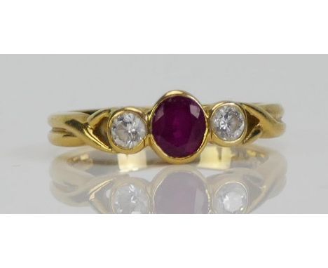 An 18ct Gold, Ruby and Diamond Ring, c. 4.67x4.24mm principal rub over set stone, c. 2.7mm brilliant cuts, size K, hallmarked