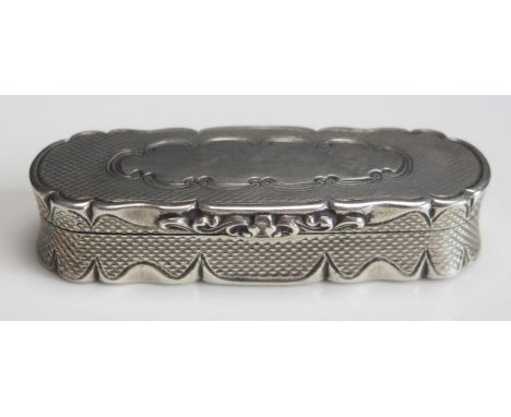 A Victorian silver snuff box, maker Edward Smith, Birmingham, 1856, of oval form with engine turned decoration within scrolli