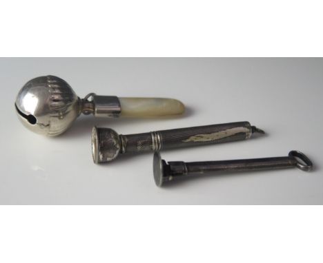 An Elizabeth II silver cigar piercer, Birmingham, 1958, a silver pipe tamper and a child's silver rattle with mother-of-pearl