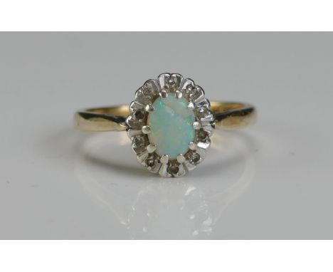 A 9ct Gold, Opal and Diamond Cluster Ring, size L.75, hallmarked, 3g 