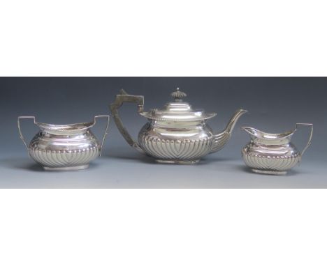 A late Victorian matched three-piece silver tea service, maker Atkin Brothers, Sheffield, 1898/1900, monogrammed of barge-sha