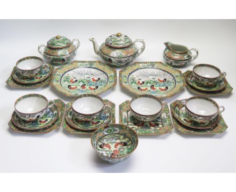A 20th century Chinese famille verte part tea service, decorated with cockerels and butterflies, includes teapot, sugar basin