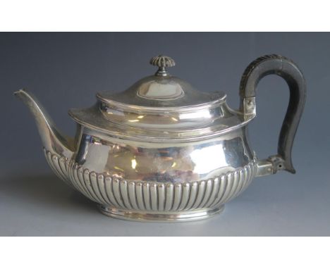A Victorian silver teapot, maker William Hutton &amp; Sons, London, 1891, inscribed, of barge shaped outline with half reeded