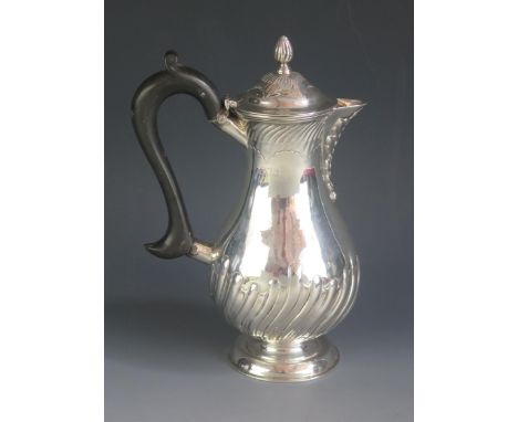 A late Victorian silver coffee pot, maker William Hutton &amp; Sons Ltd, London, 1898, with writhen decoration, on a spreadin