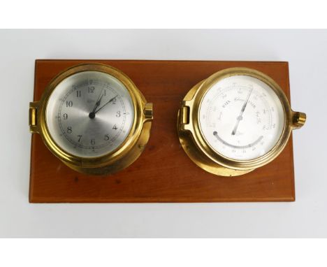 A ships brass cased bulk head timepiece, and a brass cased barometer mounted on a polished wood plaque. 