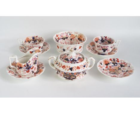 A 19th century part tea service, with Imari pattern decoration, includes slop bowl, sugar basin and cover, cream jug, two cup