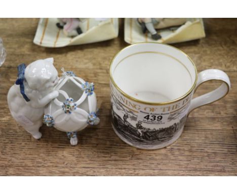 Spode 200th Anniversary of Derby mug and a Continental ceramic model of a cat with floral basket