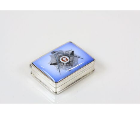 A silver box with enamel set masonic image