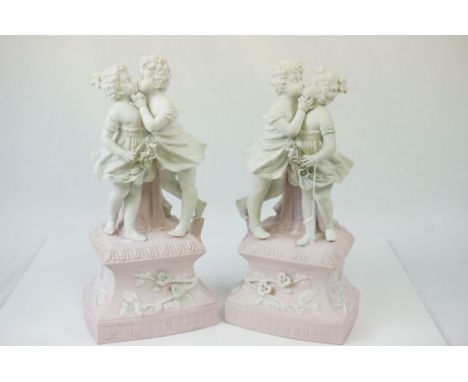 Pair of Bisque ceramic lamp bases depicting Children kissing