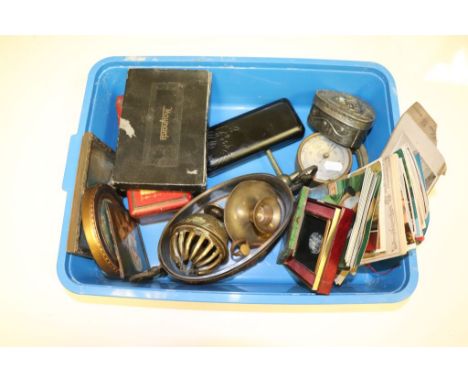 A pewter and plastic lined trinket box, a quantity of postcards, a brass chamber stick, a brass bell etc