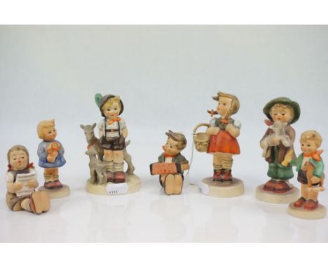 Seven Goebel Hummel figurines and a Collectors Guide