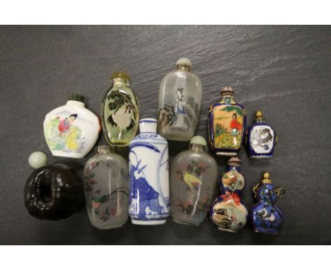 Oriental snuff bottles to include reverse painted glass, ceramic and cloissone examples, together with a carved hardwood peac