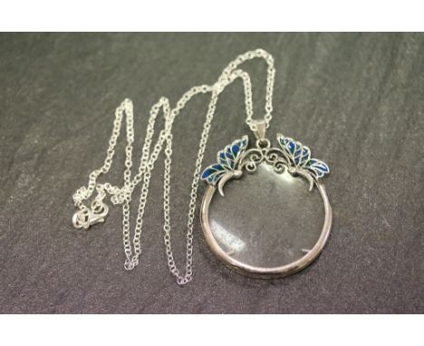 A silver and enamel set magnifying glass on silver chain