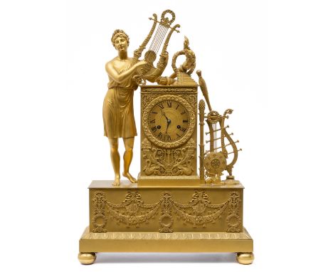 A large Empire ormolu mantel clock, First quarter 19th century, 60x41,5x14,5 cm, The case decorated with the standing figure 