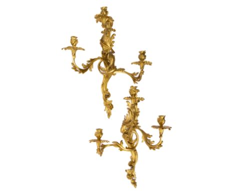 A pair of French ormolu three-light wall appliques, 19th or possibly 18th century, of Louis XV style, H ca. 61 cm, W 48 cm, P