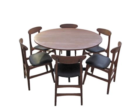 A vintage Danish Farstrup style dining suite comprising a round teak veneered table W120cm on black metal pedestal and six te