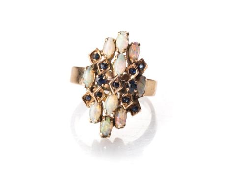 AN OPAL RING 1970s Designed as a series of steps, set with a combination of oval claw-set opals and box-shape settings, set w