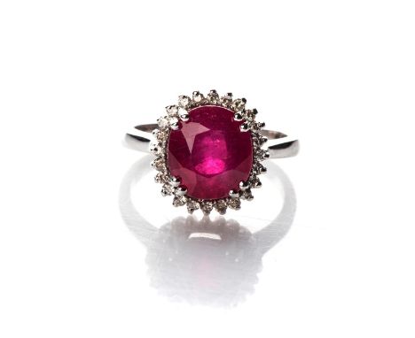 A DIAMOND RING Claw-set to the centre with an oval-cut ruby, weighing 5,75ct, accompanied by an AGL report no CO1909005716, s