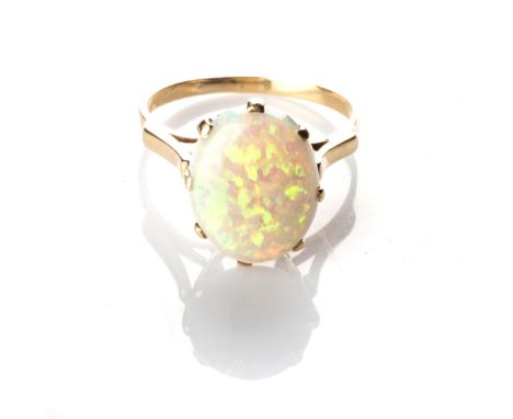 A OPAL RING Claw-set to the centre with an oval-shape opal, weighing approximately 5ct, in a 9ct gold dress, ring size M 