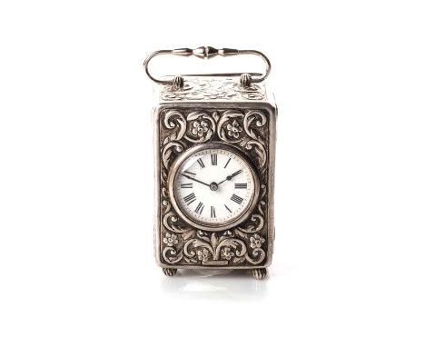 A SILVER CARRIAGE CLOCK The circular white 38mm dial with Roman numerals, calibrated outer ring with swing handle on bun feet