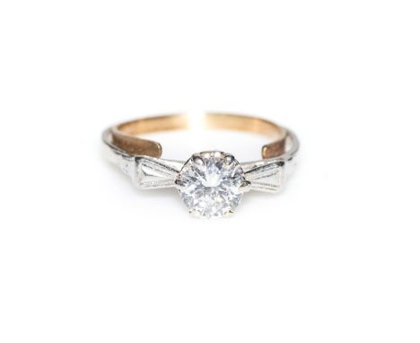 A DIAMOND RING Bezel-set to the centre with a round brilliant-cut diamond, weighing approximately 0,50ct, flanked by baguette