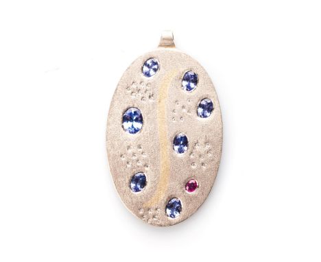 A TANZANITE PENDANT Oval, abstract-set with seven oval-cut tanzanites, with a combined weight of approximately 7ct, enhanced 