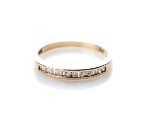 A DIAMOND ETERNITY RING Channel-set to the centre with round brilliant-cut diamonds, weighing 0,15ct, colour G-H and clarity 